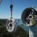 A crane lifting a wind turbine Description automatically generated