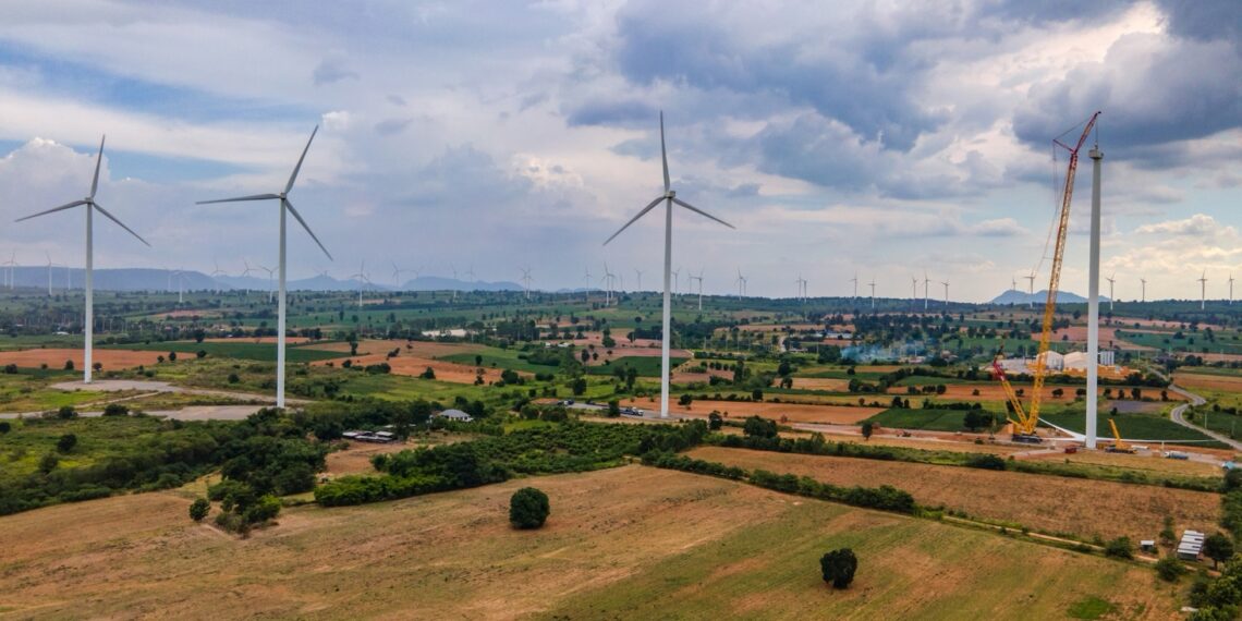 A windmills in a field Description automatically generated