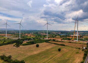 A windmills in a field Description automatically generated